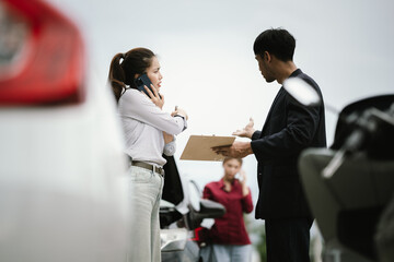 Man inspecting damaged car after crash, documenting insurance claim with mobile phone, showing frustration, analysis, and need for repair service.