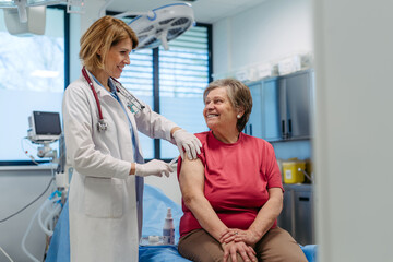Elderly patient being vaccinated by doctor.