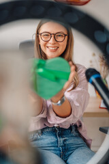 Influencer showing green heart during livestreaming session
