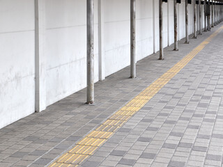 rough tactile tile for guiding visually impaired person on tile sidewalk