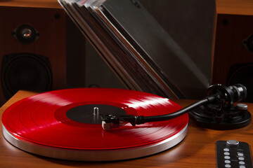 Vinyl record player with red vinyl disc. Classic vinyl record player