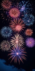 Fototapeta premium Vibrant Fireworks Display in Red, Blue, Purple and Gold Bursting Against a Dark Night Sky