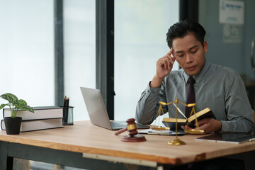 lawyer sits reading a book studying the law in a law office.