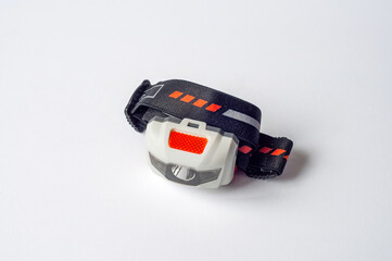 A detailed studio shot of a headlamp, designed for outdoor activities and adventures.