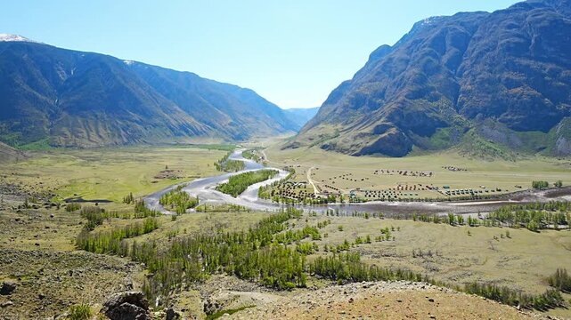 Chulyshman river winding through vast valley in Altai Russia seen from viewpoint near stone mushrooms Breathtaking Siberian landscape of mountains and flowing water