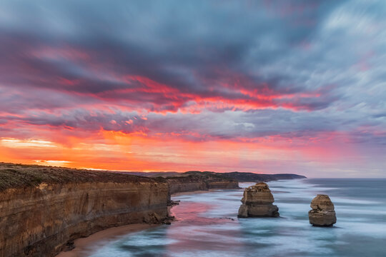 Australia, Victoria, Long exposure of Twelve Apostles and Gibson Steps in Port Campbell National Park at cloudy dawn