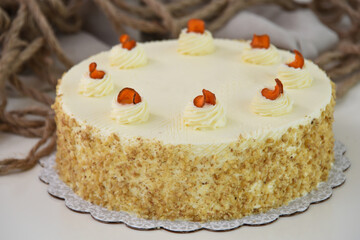 Elegant Carrot Cake with Cream Cheese Frosting and Drizzle spiced cake layers covered in smooth cream cheese frosting top is elegantly drizzled with caramel side view of delicious cafe cake