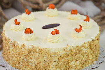 Elegant Carrot Cake with Cream Cheese Frosting and Drizzle spiced cake layers covered in smooth cream cheese frosting top is elegantly drizzled with caramel closeup side view of delicious cake