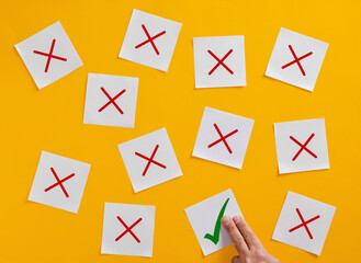 Manager choosing right answer among many wrong options placing green check mark