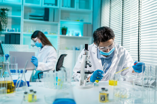 Asian male and female scientis work together in the research laboratory. 