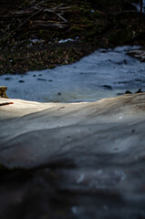 The waterfall is frozen, covered with ice in winter.