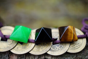 Feng Shui coins and small colored pyramids.