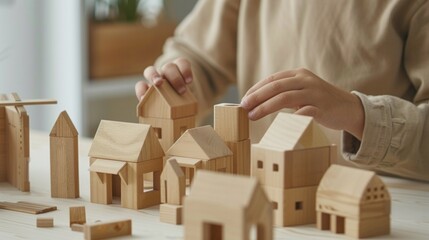 Hands building a miniature village with wooden block houses on a light surface. AI generative..