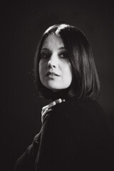 Sensual portrait of a woman with dark hair, done in a low key style.