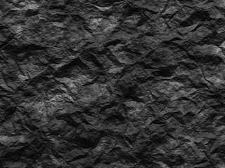 Dark rocky texture with rough, sharp edges and irregular formations.