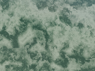 Marble surface with a blend of dark and light green, featuring subtle textures.