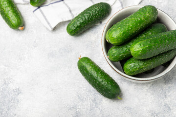 Cucumber on wooden background. Slice of cucumber on background. Fresh organic green cucumbers gherkin. Vegan. Salad ingredient. Farm vegetables. Cut vegetables with knife. Space for text. Copy space