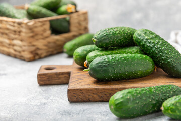 Cucumber on wooden background. Slice of cucumber on background. Fresh organic green cucumbers gherkin. Vegan. Salad ingredient. Farm vegetables. Cut vegetables with knife. Space for text. Copy space