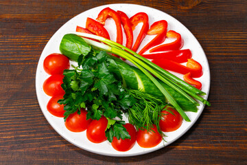 Fresh vegetables arranged on a plate for a healthy meal