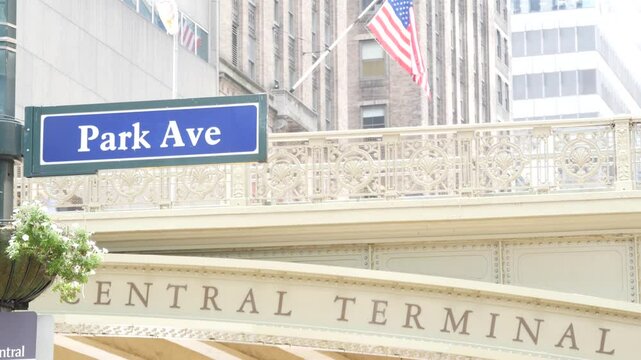 New York City Grand Central Terminal, 42 street, Park Avenue, Pershing Square bridge architecture. Midtown district railroad hub, railway transport. American flag, NY crossroad, intersection road sign