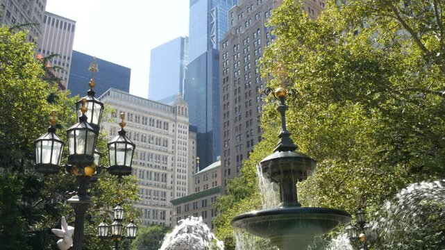 New York City Lower Manhattan, Downtown Financial District architecture, United States. High-rise buildings on Broadway street, USA. American urban scene, fountain in City Hall Park, NYC. Greenery.