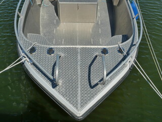 Small aluminum boat in calm marina of Ralswiek, Ruegen.
