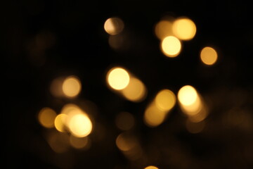 Christmas lights in bokeh. Outside in December. Red and fire orange bokeh on a black background, bokeh abstract background, modern technological abstract background. Orange Christmas background, Xmas 