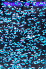 Image of many bubbles in colorful water.