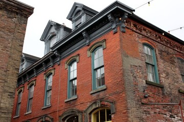 Fototapeta premium Historic brick building showcasing architecture and character in an urban area during a cloudy day
