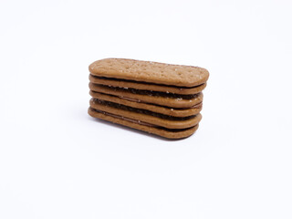 Stack of chocolate cream sandwich biscuits on a white background, sweet and crunchy with visible sugar crystals