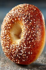 Delicious breakfast bagel on dark plate next to a cup of fresh coffee. On bistro countertop.	
