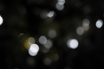 white and fire silver bokeh on a black background, bokeh abstract background, modern technological...