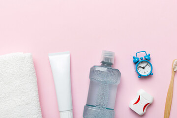 Mouthwash and other oral hygiene products on colored table top view with copy space. Flat lay. Dental hygiene. Oral care products and space for text on light background. concept