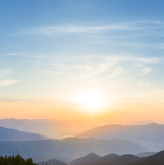 mountain silhouette in blue mist at the sunrise
