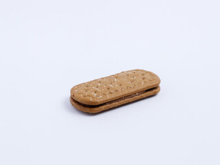 Single chocolate cream sandwich biscuit isolated on white background