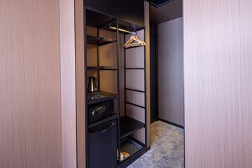 entrance to a hotel room, wardrobe with a safe inside