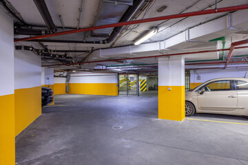 Fototapeta premium Underground parking garage with cars
