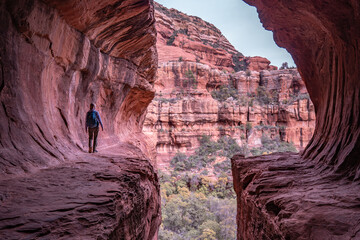 Woman walking Subway Cave in Sedona AZ