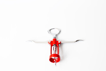 Red corkscrew isolated on a white background.  Flat lay, top view. Wine equipment. Copy space,...
