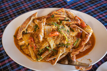 Stir-fried crab curry, soft shell crab yellow curry with sweet pepper and vegetables.  in a restaurant by the sea, Phuket