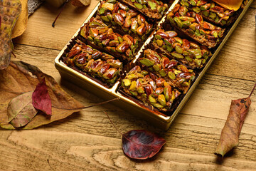 Sweet food Turkish delight on wooden background, assorted pistachio and candy for decorated backdrop