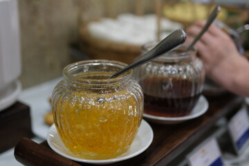 Close-up view of the spoon picking up cooked orange jam from pan in slow motion. High quality 4k...