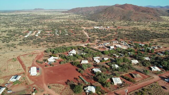 Reverse aerial view of the town of Umuwa and surrounding landscape, South Australia, Australia. August 2022.