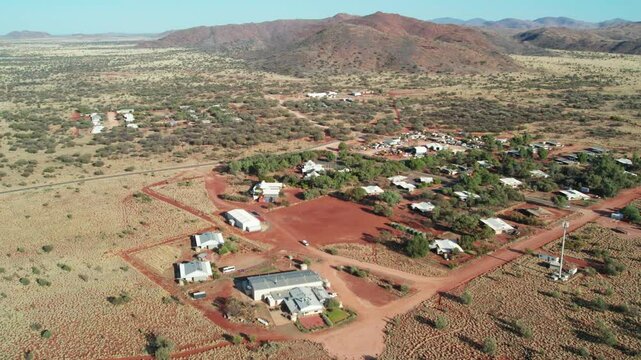 Sideways aerial view of the town of Umuwa and surrounding landscape, South Australia, Australia. August 2022.