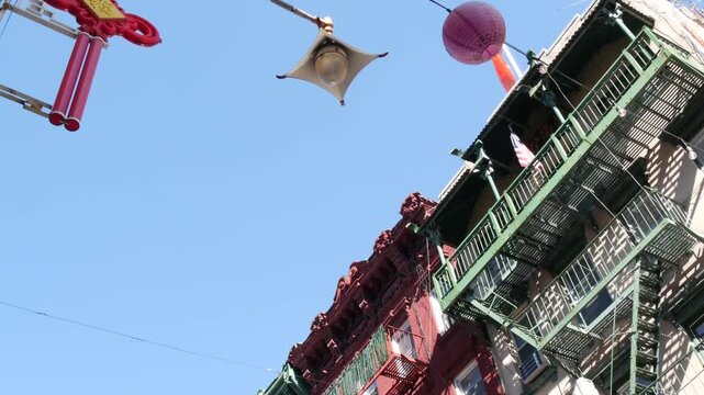 New York City, United States. Manhattan Chinatown Mott street, chinese ethnic district buildings architecture, USA. American red brick house in little China. Fire escape ladder in NYC. Paper lanterns.