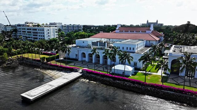Establishing drone shot of West Palm Beach huge mansions in a residential zone during the day in Florida, USA