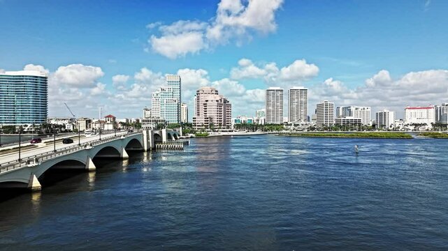 Aerial: cityscape with Royal Park Bridge, One Flagler and Phillips Point building during the day in West Palm Beach, Florida, USA, pan drone shot