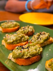 Persea americana (Avocado) based bruschetta, a classic Italian appetizer, featuring ripe avocados on toasted bread.