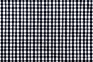 The texture of linen fabric in a large cell of black and white. Scottish tailoring material. checkered fabric