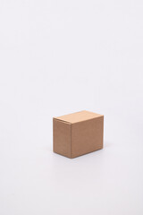 Cardboard Box with Open Lid on White Surface grey box with the lid open against a white background